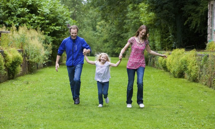 Parents walking with daughter