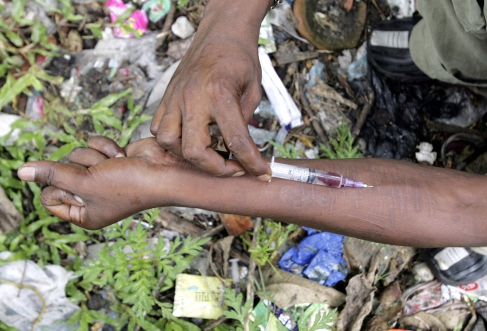 An injecting drug user injects himself with Fortwin on a roadside in Siliguri
