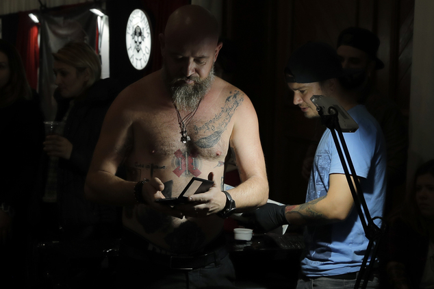 In this picture taken on Sunday, Oct. 16, 2016, a man gets a tattoo during the International Tattoo Convention Bucharest 2016 in Bucharest, Romania. AP Photo/Vadim Ghirda)