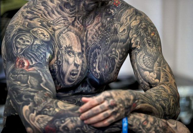 In this picture taken on Sunday, Oct. 16, 2016, well-known tattoo collector Yall Quinones, from Puerto Rico, shows off his tattoos during the International Tattoo Convention Bucharest 2016 in Bucharest, Romania. (AP Photo/Vadim Ghirda)